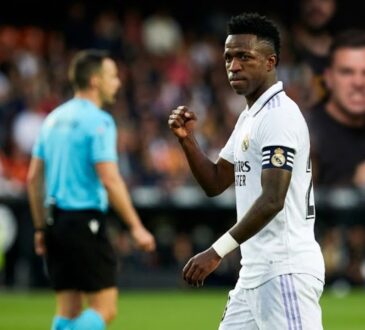 Vinícius Júnior Real Madrid football star in stadium emotional moment after FIFA racism ruling.